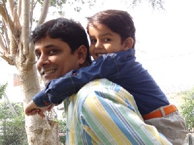 Boy playing on dad's shoulder